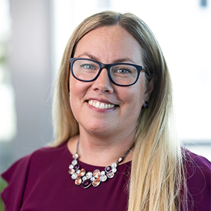 Portrait photo of Maura in professional attire.