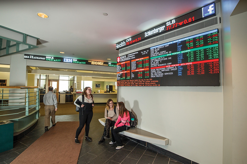 Students gather in the lobby of the business school