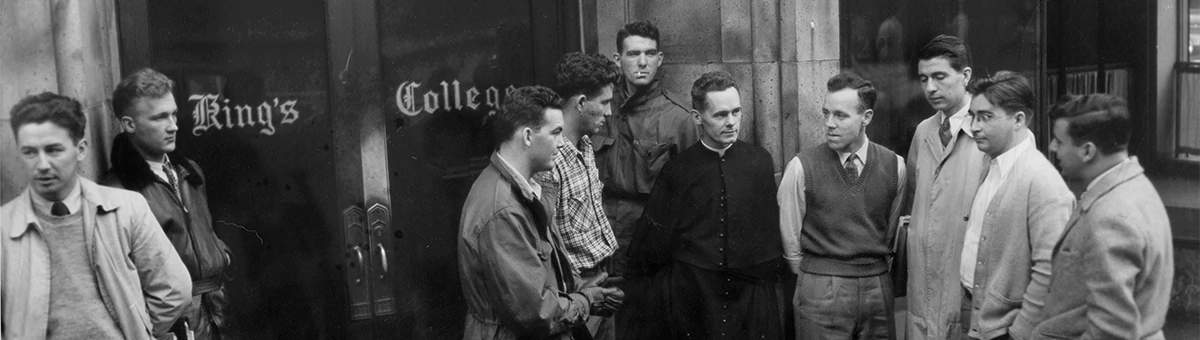 Men pose outside a King's building in the 1940s